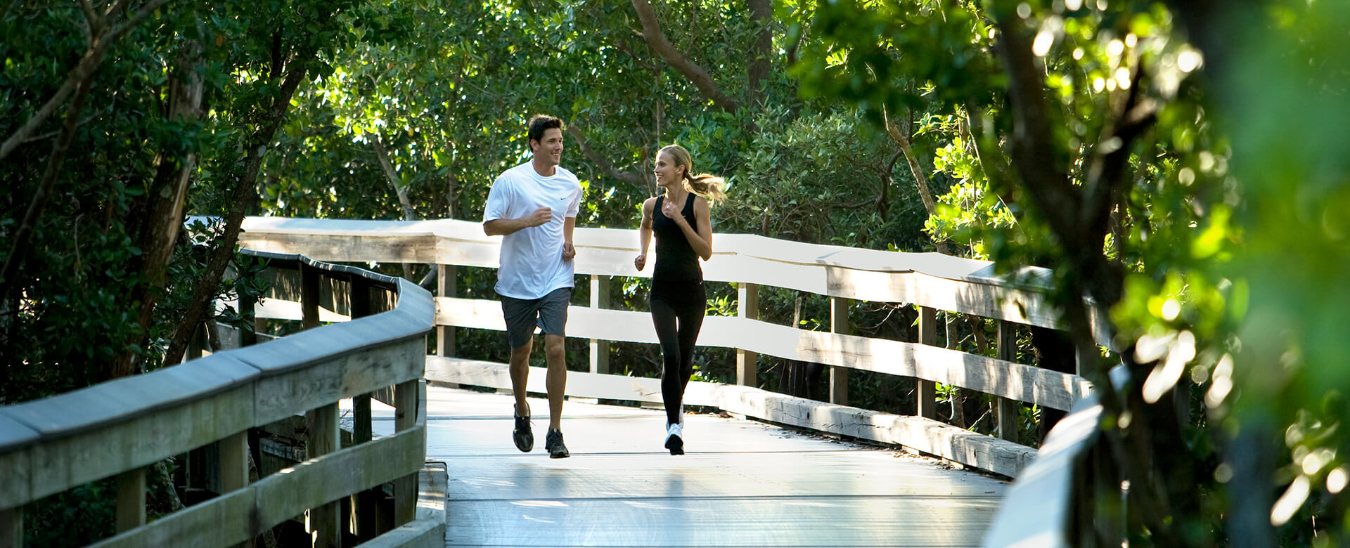 couple running on boardwalk