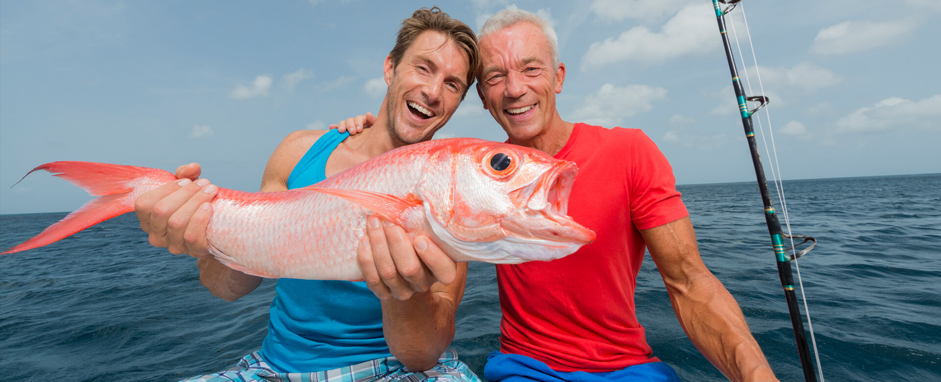 men posing with a fish in naples