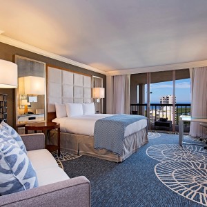 King sized bed and private balcony in our Signature Gulf View guest room